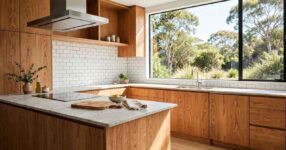 Modern Australian kitchen with a white subway tile splashback, timber cabinetry and bright natural light