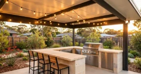 Covered alfresco outdoor kitchen with stone benchtop and built-in BBQ in an Australian backyard