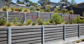 Modern concrete sleeper retaining wall with terraced garden beds in an Australian suburban backyard